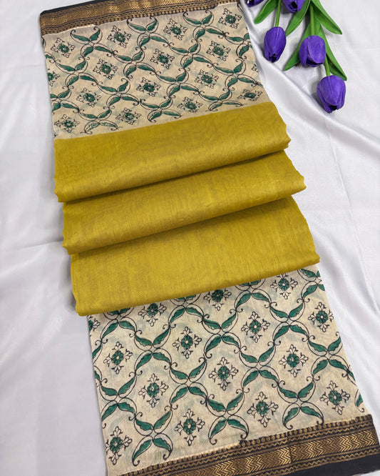 Folded Shuchi Label office wear yellow saree with green and beige pattern on a white background