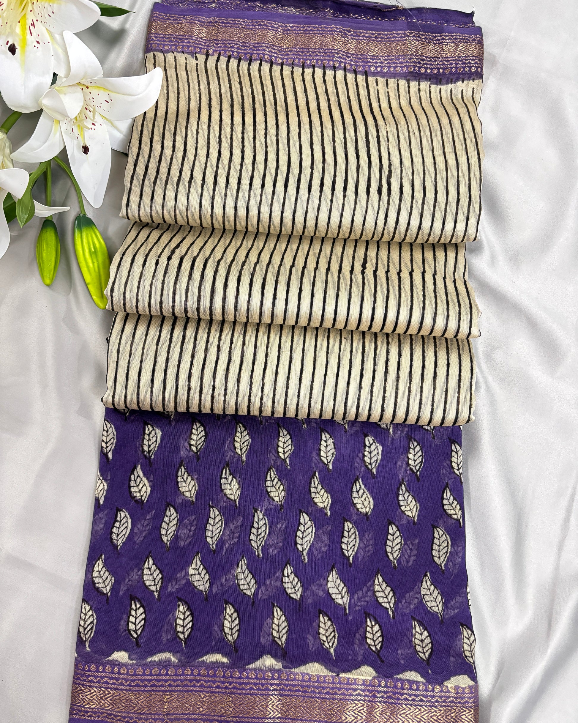 Office wear saree with purple and white patterns on a white background