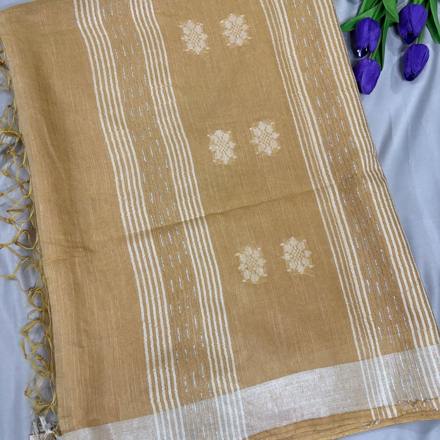 Yellow scarf with white patterns on a light gray background