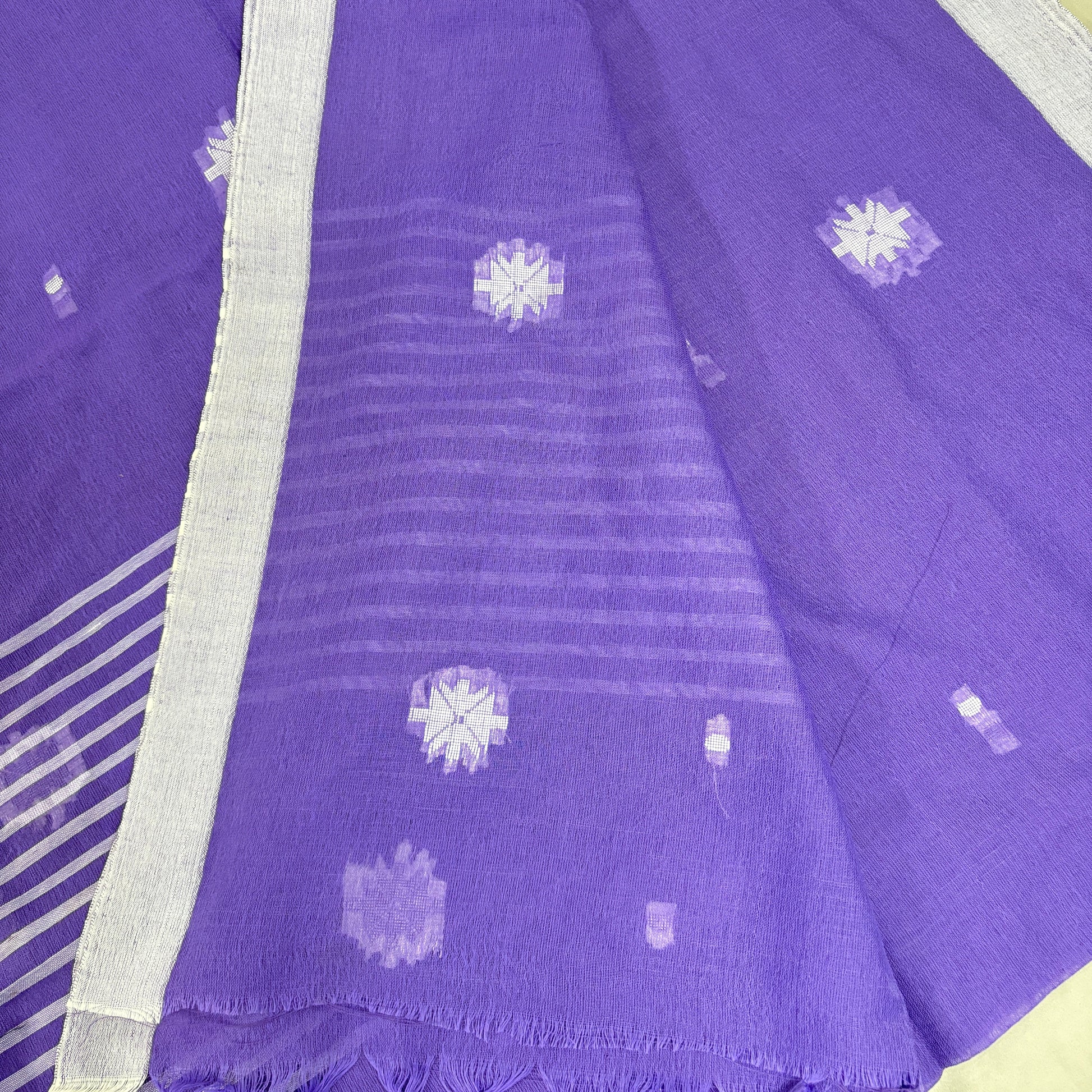 Purple saree with white floral patterns on a yellow background