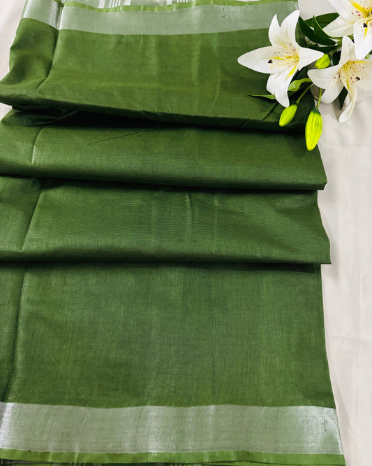 Green linen Shuchi Label saree with silver border on a white background