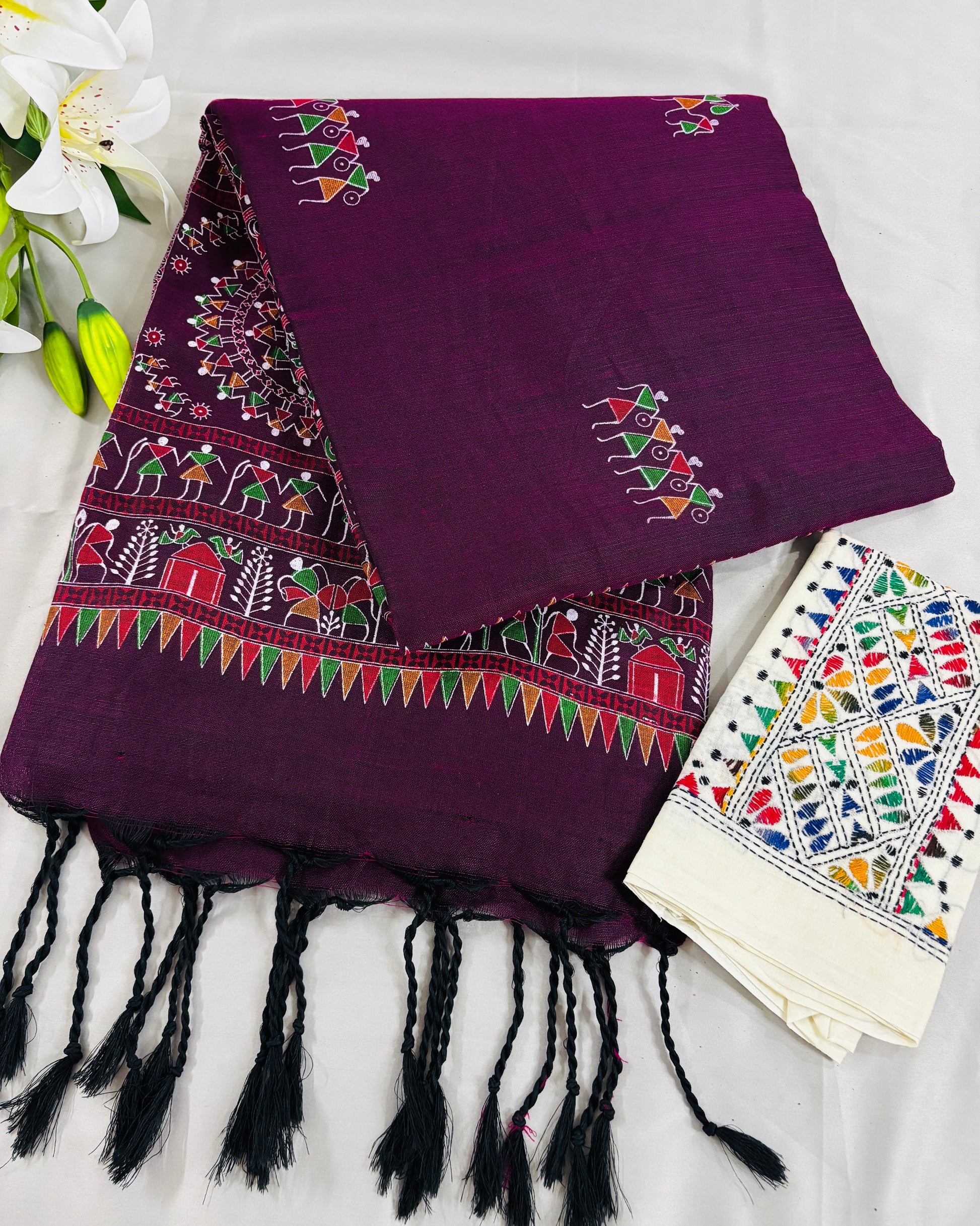 Purple madhubani printed Shuchi Label saree with colorful patterns on a white background